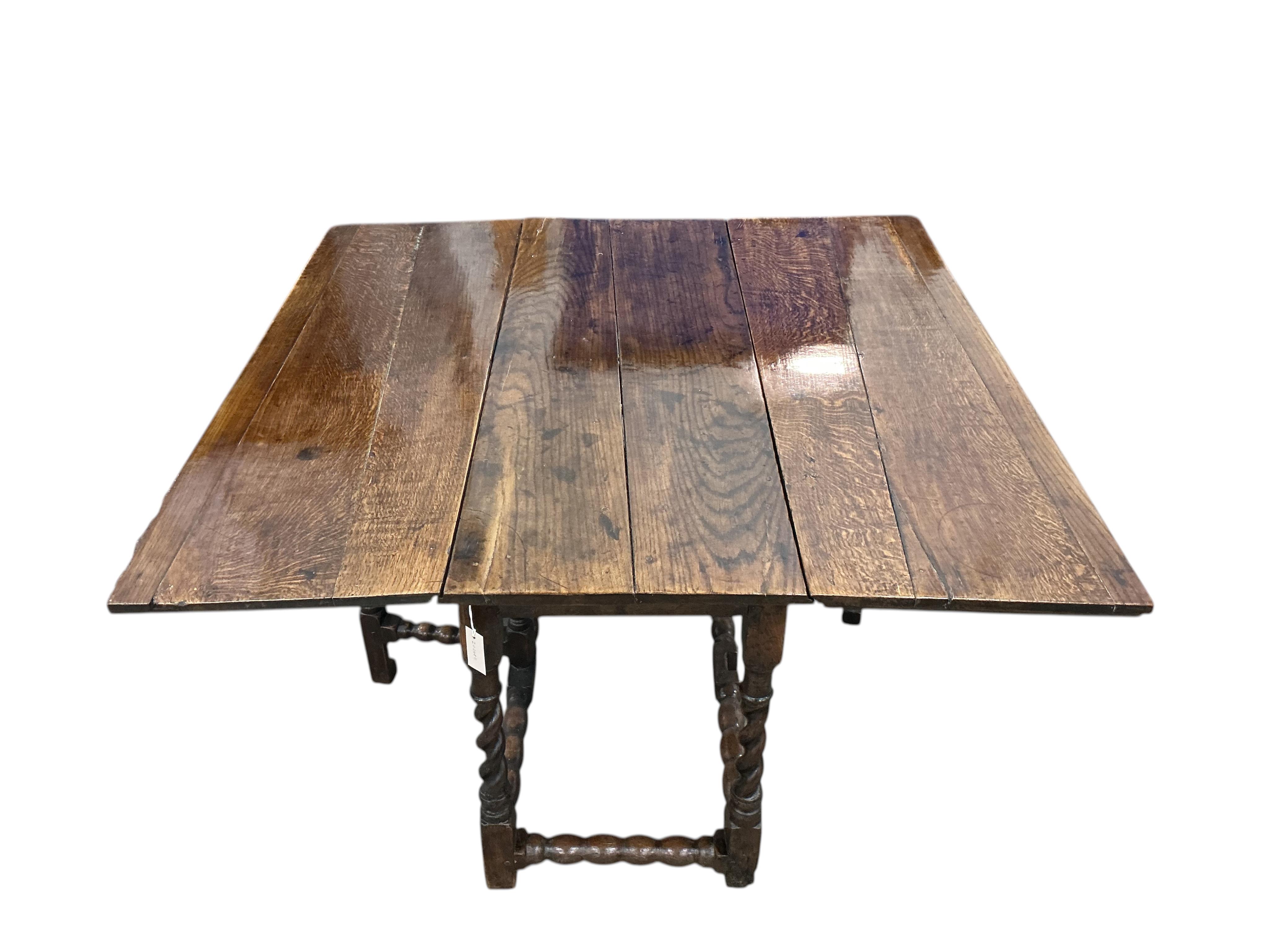 A late 17th / early 18th century oak gateleg table with barley twist legs, width 134cm, length 140cm extended, height 73cm